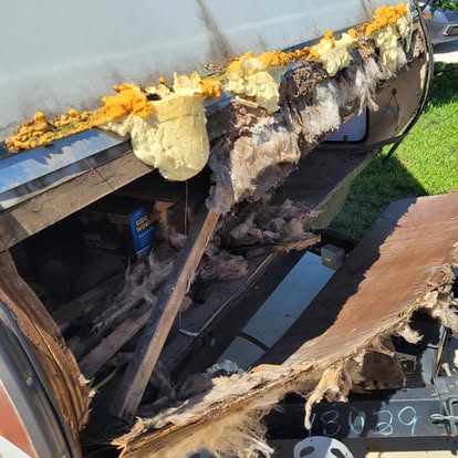 Wood rot and water damage inside an RV wall caused by a roof leak